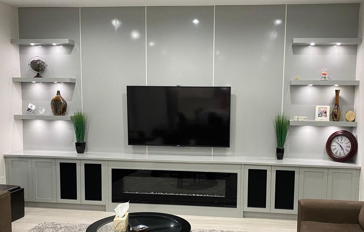 Grey gloss media wall with Shaker base cabinets and a built-in fireplace